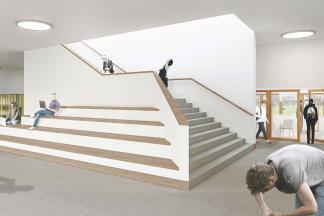 Aus dem zentralen Foyer führt eine offene Treppe mit zusätzlichen Sitzstufen in die oberen Geschosse.